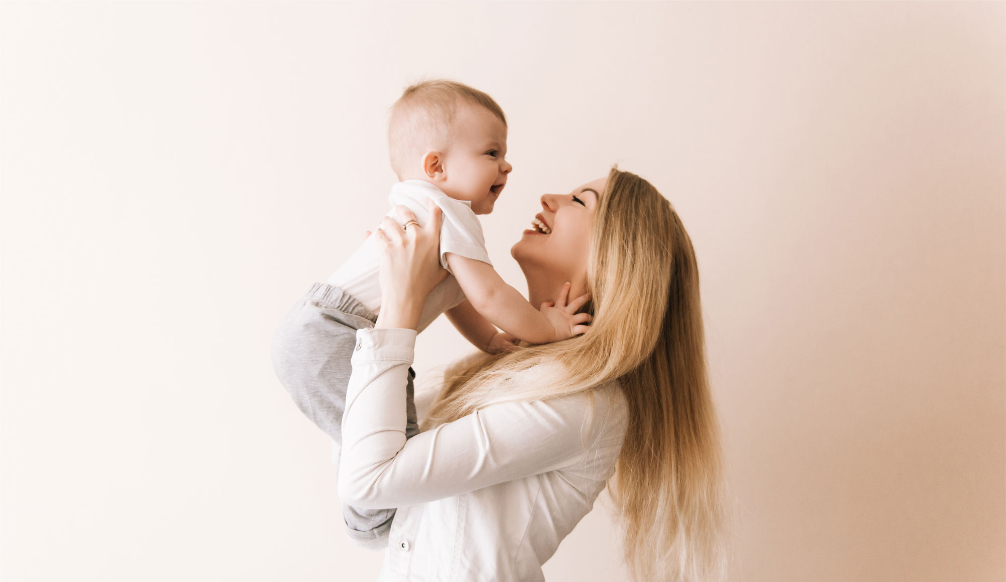 A smiling mother holding her baby.